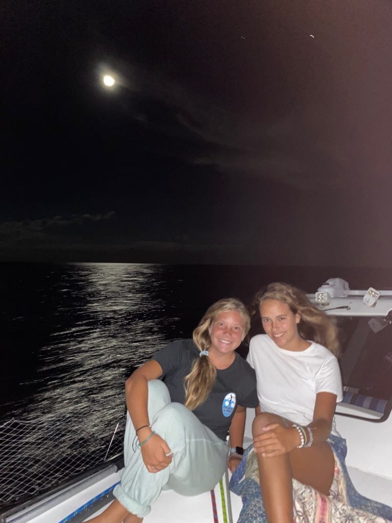 Friends on moonlight sailing cruise with full moon Ocean City Maryland