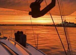 Romantic sunset cruise Ocean City aboard Alyosha sailing catamaran with couple watching sunset