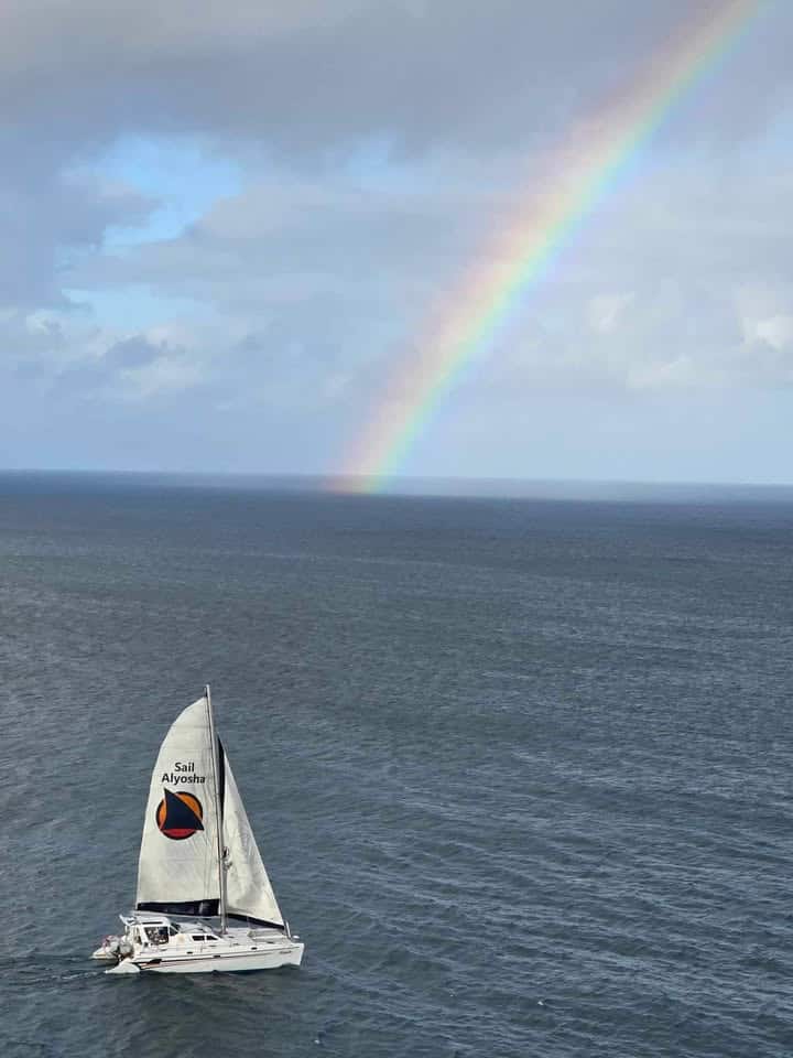 Ocean sailing on Alyosha catamaran with rainbow over Atlantic waters heading back to Ocean City from USVI