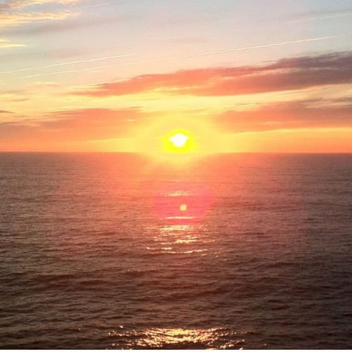 Sunset cruise Ocean City catamaran view of sun setting over Atlantic Ocean waters