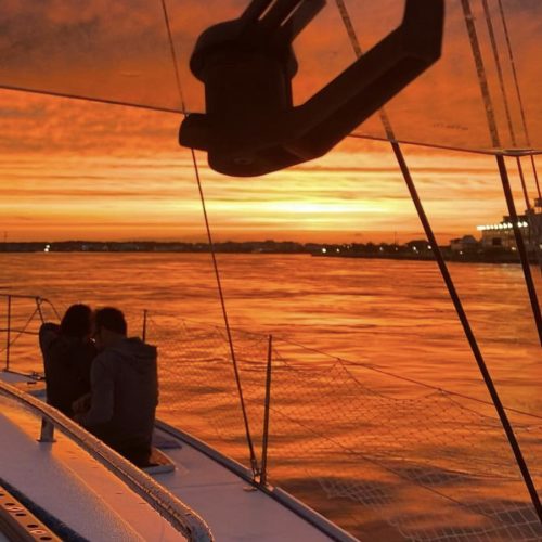 Romantic sunset cruise Ocean City aboard Alyosha sailing catamaran with couple watching sunset